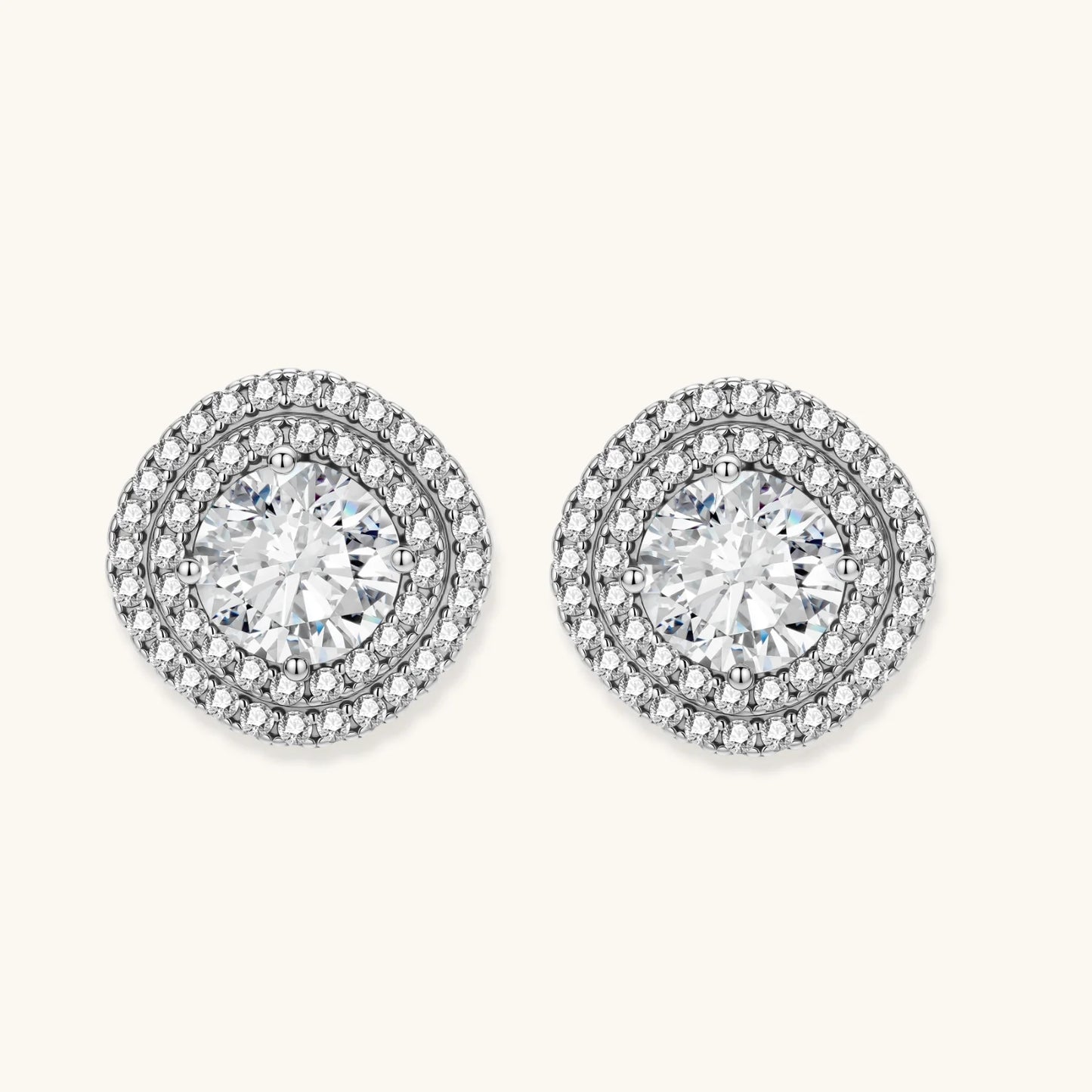 Double halo sterling silver stud earrings with brilliant round moissanite center stones and pavé crystal accents