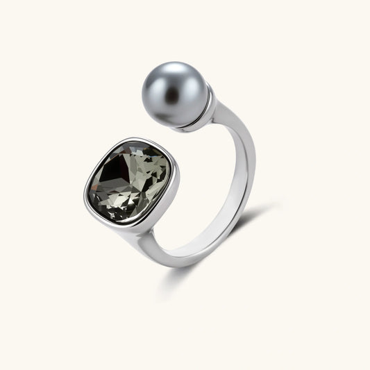 Modern adjustable ring with smoky zircon stone and metallic sphere in platinum-plated copper finish on neutral background.